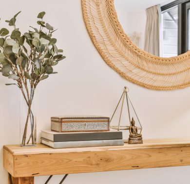 Decoration of a modern residential house in the form of a round mirror Decoration of a modern residential house in the form of a round mirror and souvenirs on the table